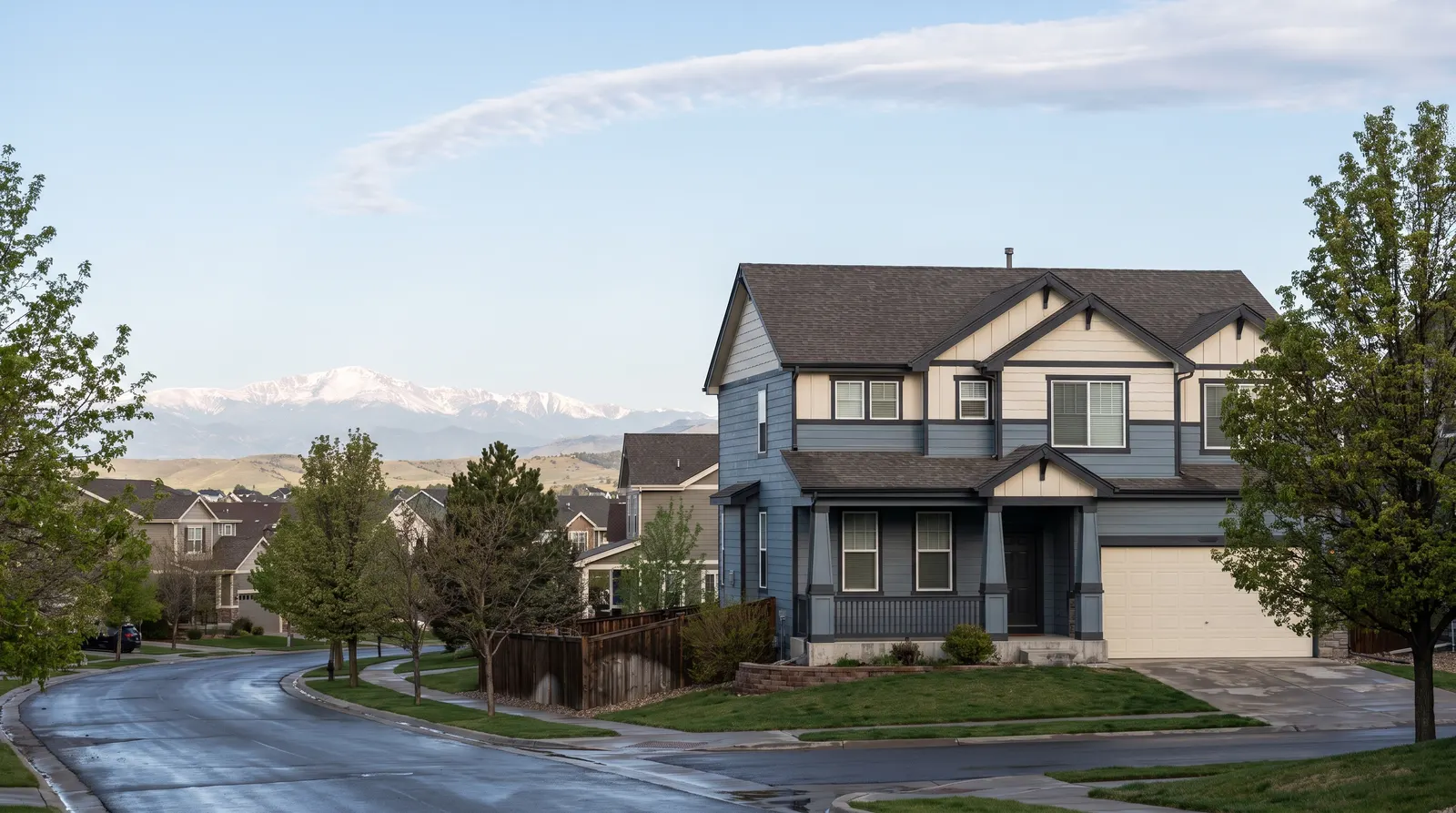Newly painted suburban house in crisp spring light with foothills and a clear sky behind