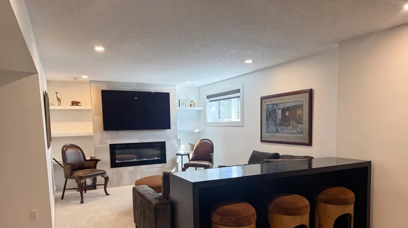 A finished basement living area with bright white walls