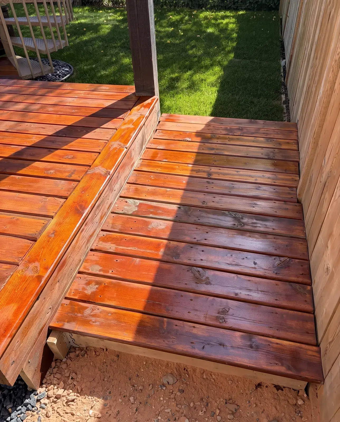 Cedar deck step with stain going on, before it has evened out